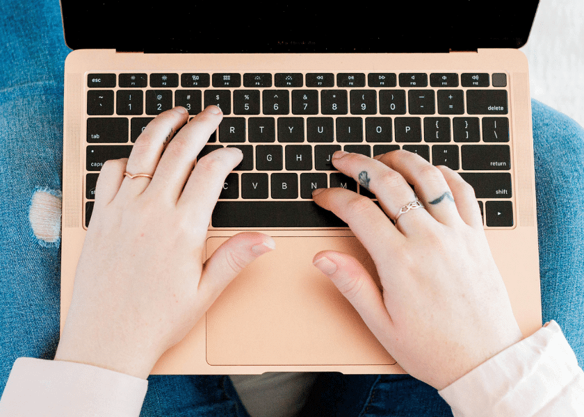 A person is typing on a keyboard.